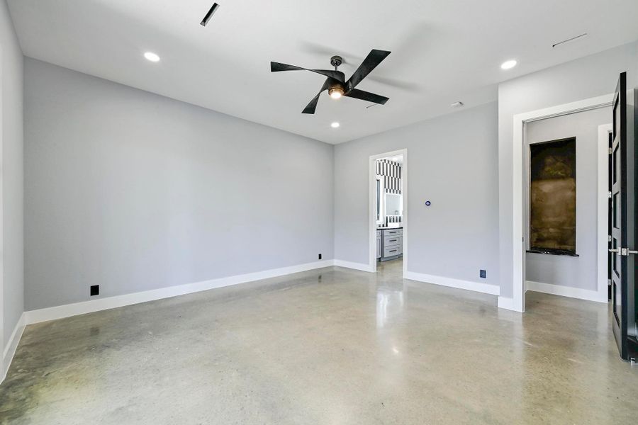 The oversized primary suite is a private retreat for rest and relaxation with tall ceilings, LED recessed lighting, and a modern ceiling fan. The oversized primary suite is a private retreat for rest and relaxation with tall ceilings, LED recessed lighting, and a modern ceiling fan.