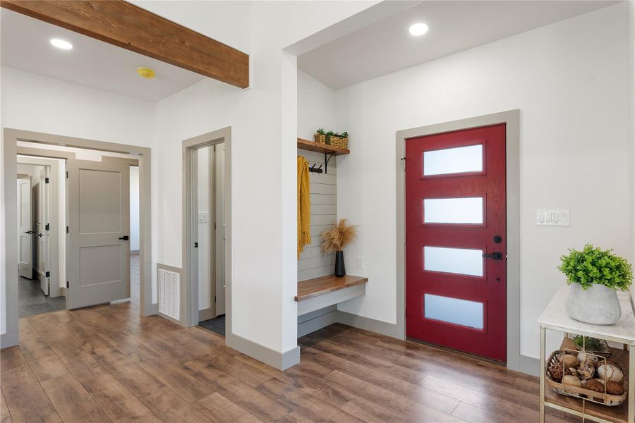 Foyer entrance featuring beamed ceiling, recessed lighting, and wood finished floors