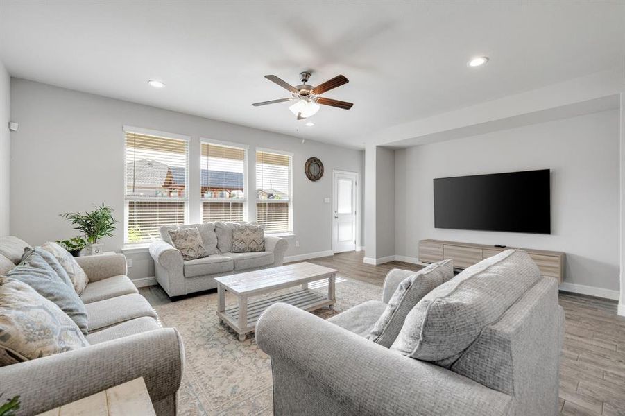 Living area featuring recessed lighting, a ceiling fan, and light wood-style floors