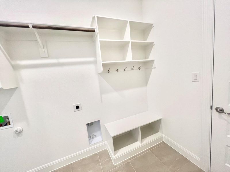 Mudroom featuring baseboards and tile patterned flooring Mudroom featuring baseboards and tile patterned flooring