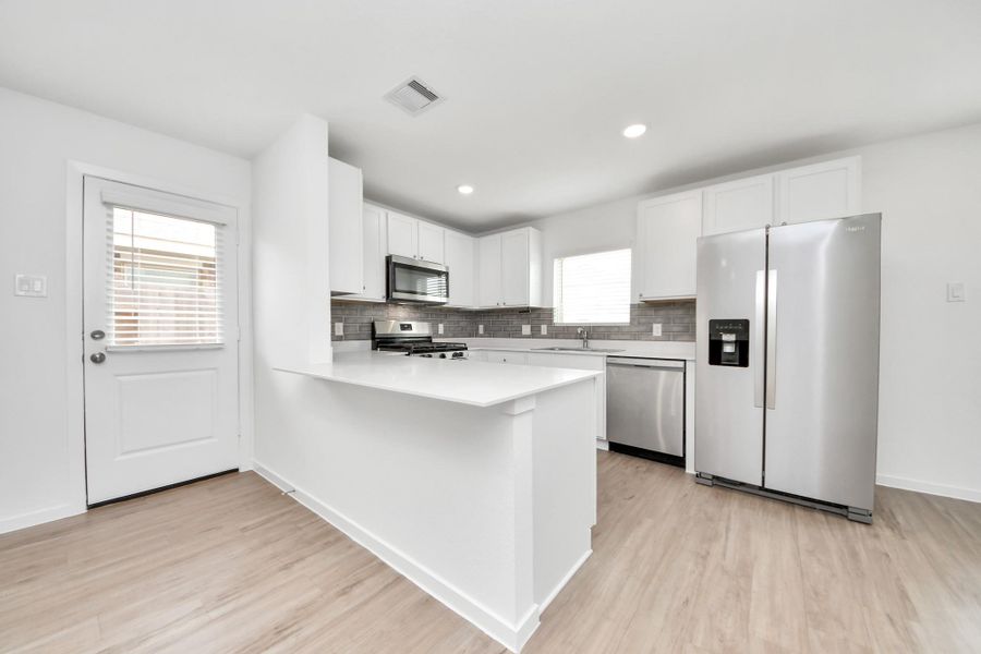 Large peninsula with seating and ample prep space.