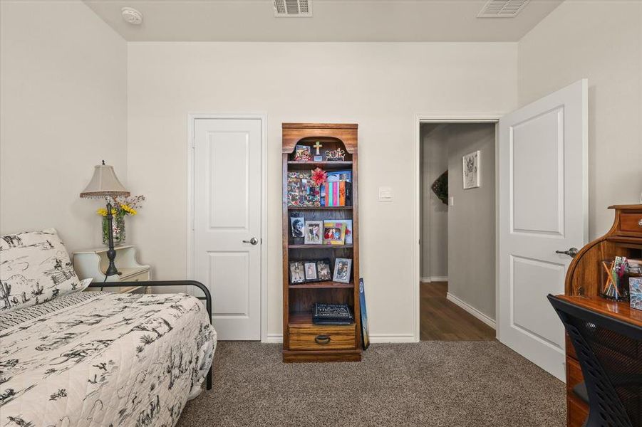 Carpeted bedroom featuring baseboards Carpeted bedroom featuring baseboards
