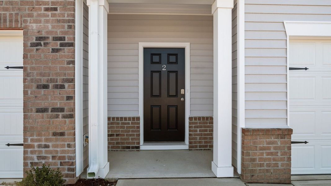 Exterior details and patio area of a home in The Townes at Ridgewood Farms, Winterville (Image 3).