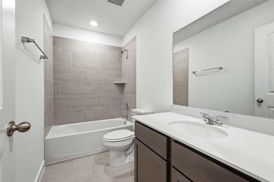 Bathroom featuring vanity and shower / bath combination