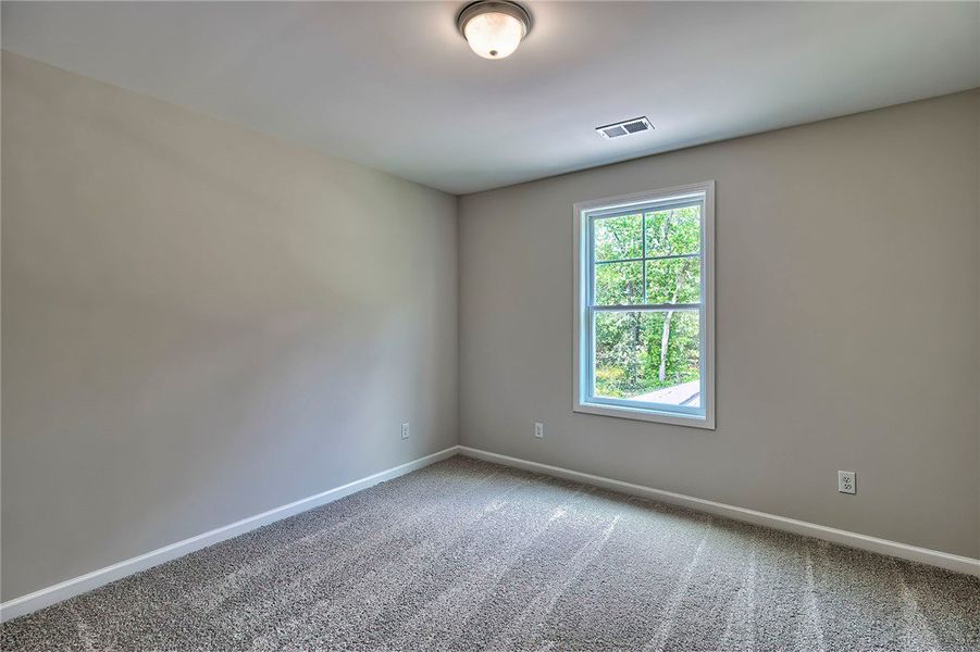 This cozy room offers carpet flooring and a window