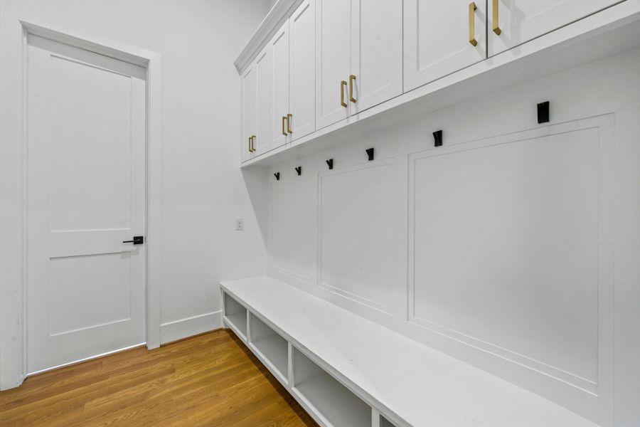 Custom mudroom with built-in bench, upper cabinetry, and organized storage—designed for effortless everyday living.