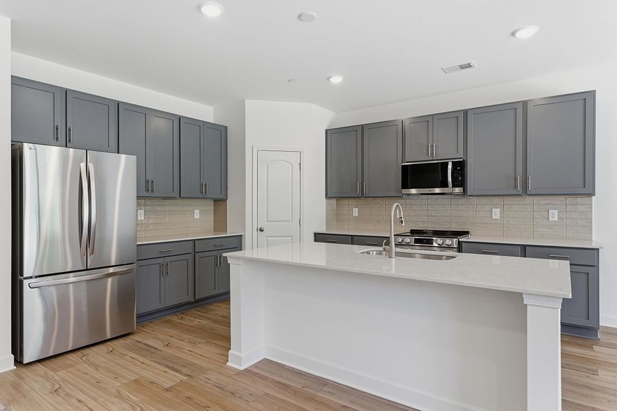 A kitchen with black cabinets. A kitchen with black cabinets.