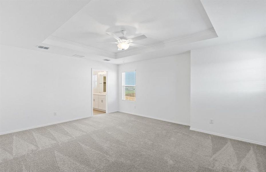 Elegant owner's suite with Tray ceiling*real home pictured