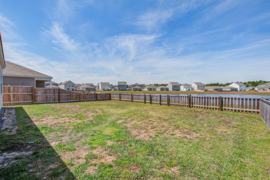 Exterior details and patio area of a home in Pine Hills at Cane Bay, Summerville (Image 28).