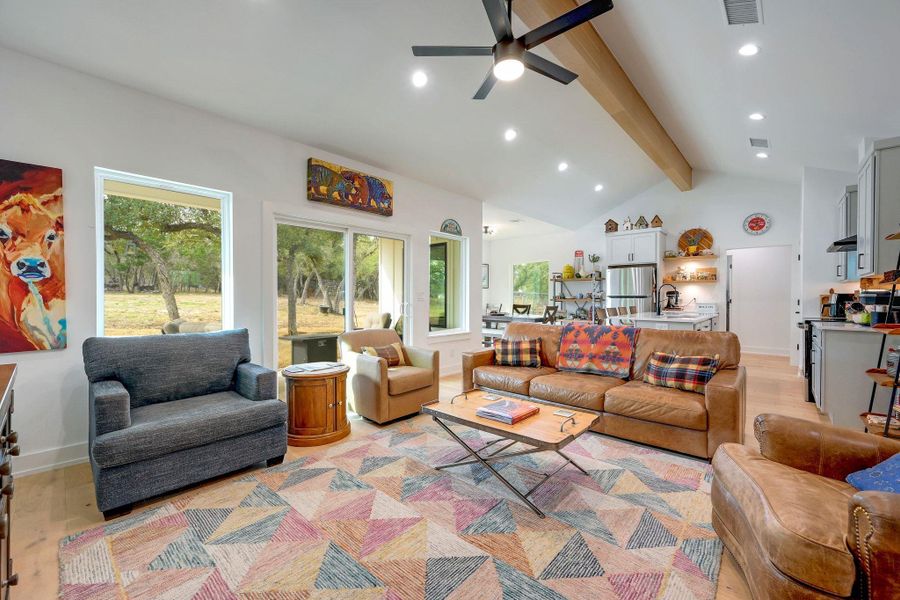Living room with light wood finished floors, a ceiling fan, and recessed lighting