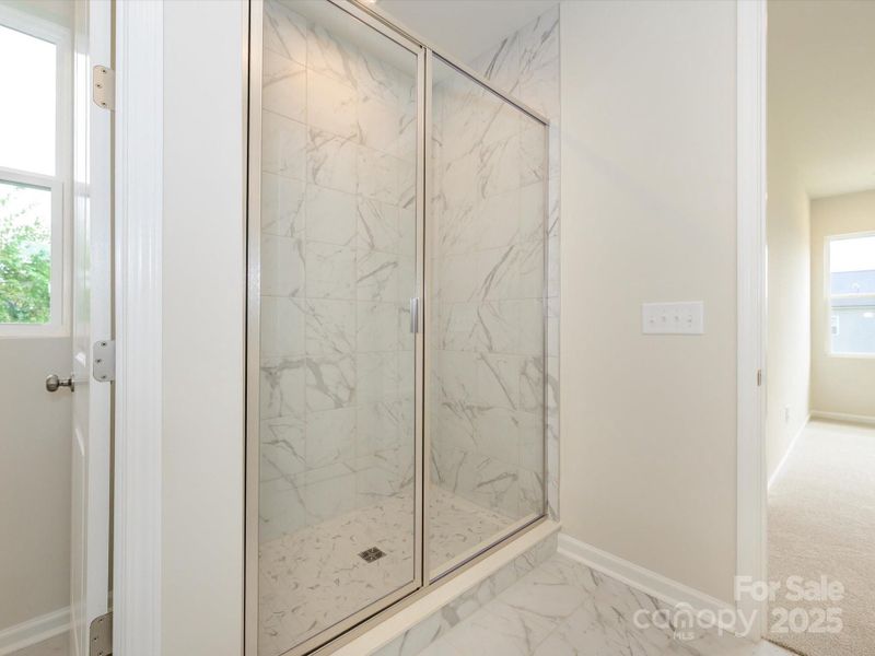 Walk-in shower with modern tile walls. Walk-in shower with modern tile walls.
