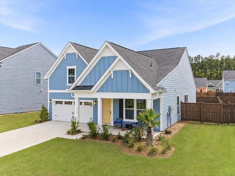 Front exterior of a new home in Homecoming, Ravenel, SC, highlighting curb appeal (Image 25). Front exterior of a new home in Homecoming, Ravenel, SC, highlighting curb appeal (Image 25).