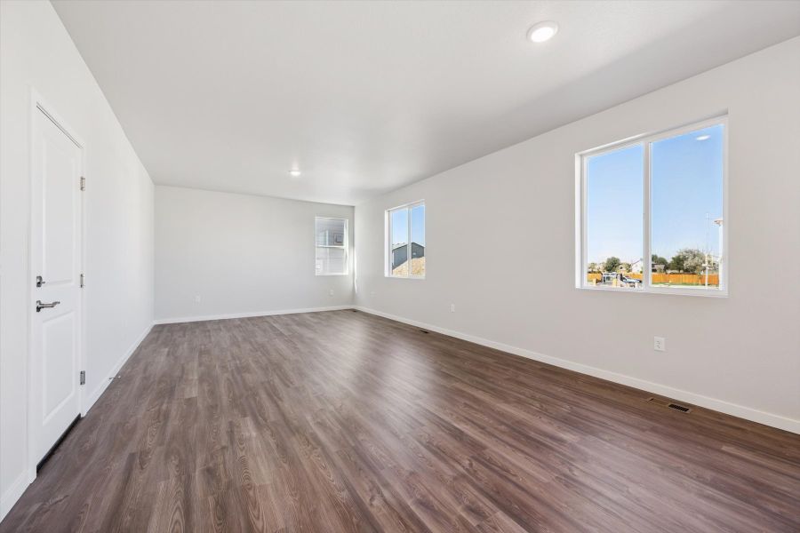 A room with a wood floor and windows. A room with a wood floor and windows.