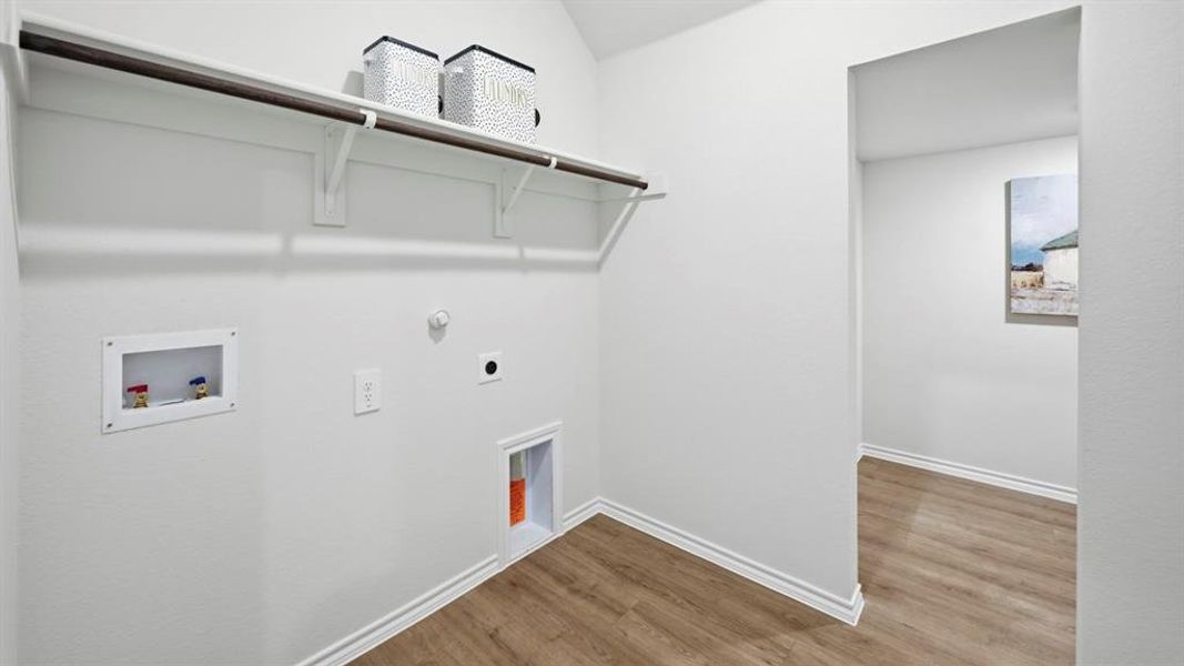 Laundry room with gas dryer hookup, hookup for a washing machine, wood finished floors, and electric dryer hookup Laundry room with gas dryer hookup, hookup for a washing machine, wood finished floors, and electric dryer hookup