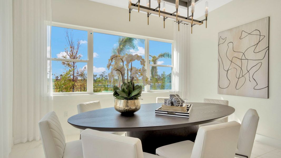 The Dining Room of a DRB Homes Grand Eider model, which is a home plan offered at Serengeti in Spring Hill, FL.