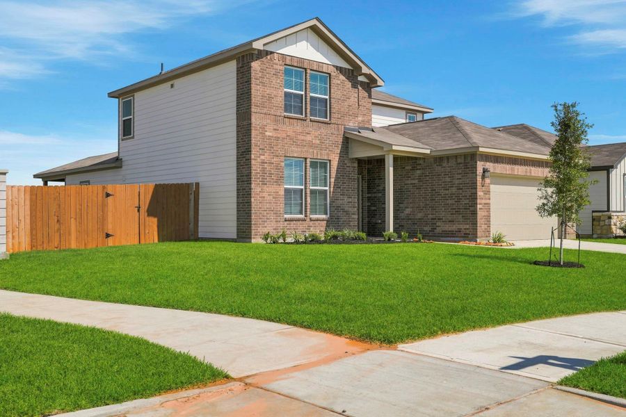 Front exterior of a new home in Mirabella, Brookshire, TX, highlighting curb appeal (Image 2). Front exterior of a new home in Mirabella, Brookshire, TX, highlighting curb appeal (Image 2).