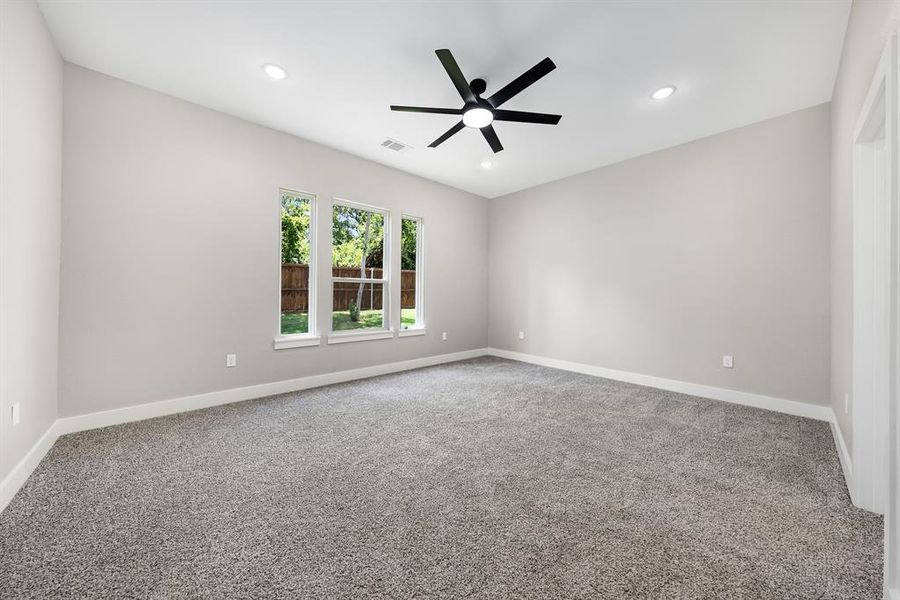 Carpeted Primary bedroom with ceiling fan and recessed lighting Carpeted Primary bedroom with ceiling fan and recessed lighting