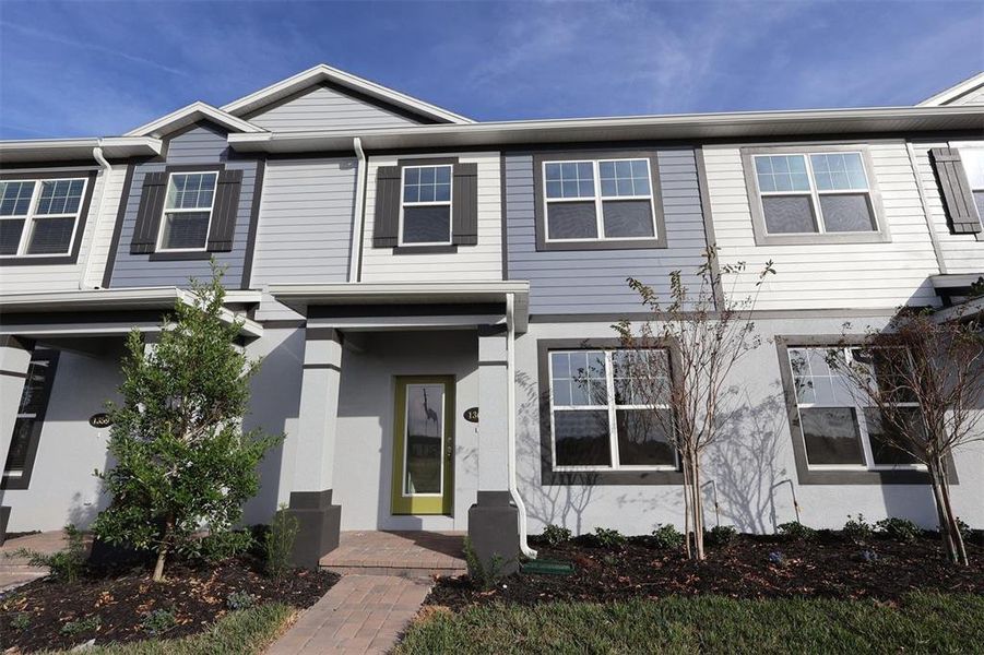 Front exterior of a new home in Center Lake on the Park, St. Cloud, FL, highlighting curb appeal (Image 2). Front exterior of a new home in Center Lake on the Park, St. Cloud, FL, highlighting curb appeal (Image 2).