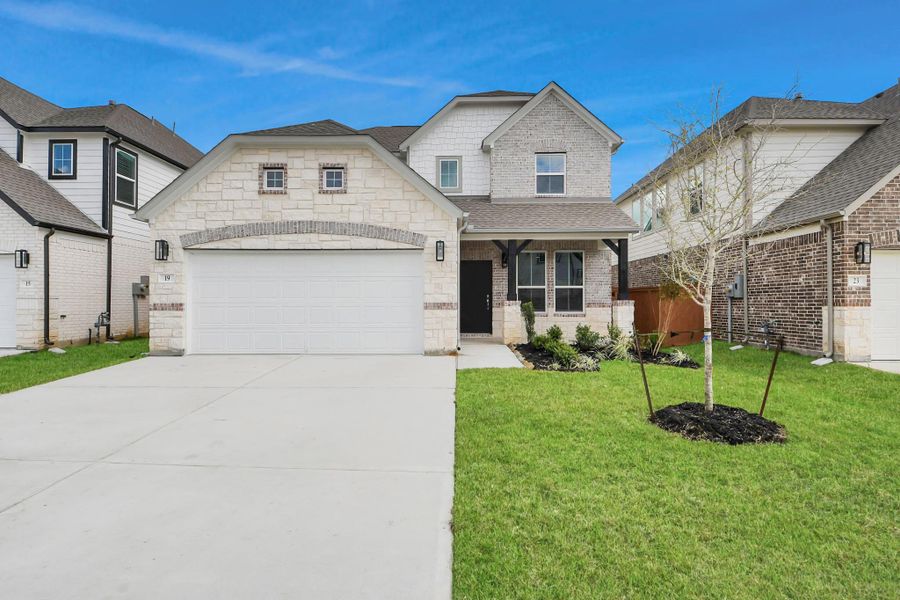 This home boasts lush green grass and meticulous landscaping. Its premium elevation showcases an exquisite blend of brick and stone features, complemented by modern coach lighting.
