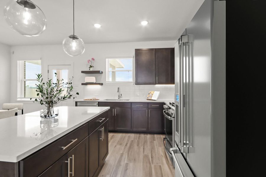 Modern kitchen with dark stain cabinets and quartz countertops