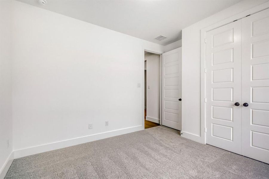 Unfurnished bedroom with carpet flooring and a closet
