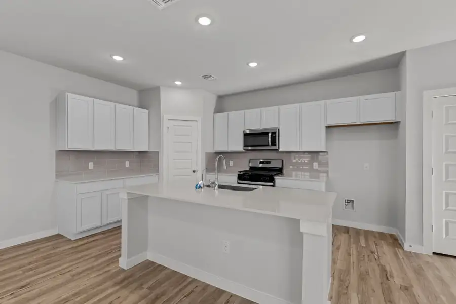 A kitchen with white cabinets. A kitchen with white cabinets.