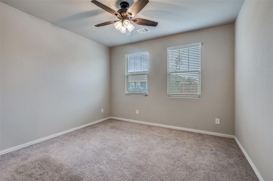 Unfurnished room with light colored carpet and ceiling fan