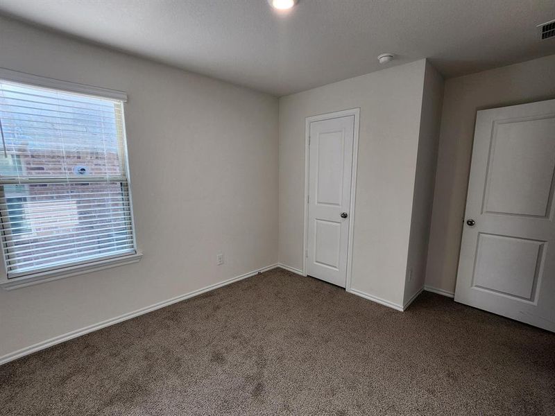 Unfurnished bedroom featuring carpet and baseboards