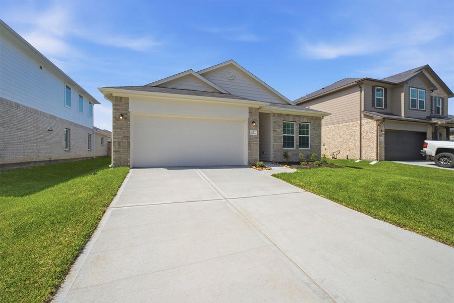 Front exterior of a new home in Steed Landing, Texas City, TX, highlighting curb appeal (Image 2). Front exterior of a new home in Steed Landing, Texas City, TX, highlighting curb appeal (Image 2).