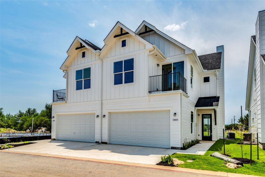 Modern white facades and attached garages define these inviting townhome residences. Modern white facades and attached garages define these inviting townhome residences.