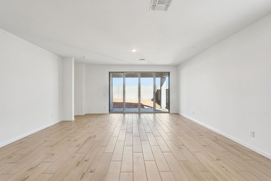 Great room with 4 panel slider to covered patio. Finishes and colors may vary by community.