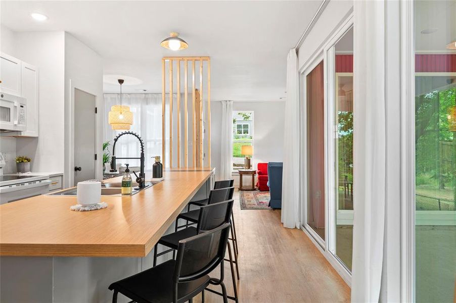 Dining room with sink and light hardwood / wood-style floors