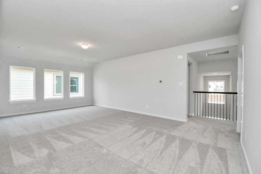 Come upstairs and enjoy a day of leisure in this fabulous game room! This is the perfect hangout spot or adult game room! Features plush carpet, high ceilings, custom paint and windows for plenty of natural light. Come upstairs and enjoy a day of leisure in this fabulous game room! This is the perfect hangout spot or adult game room! Features plush carpet, high ceilings, custom paint and windows for plenty of natural light.