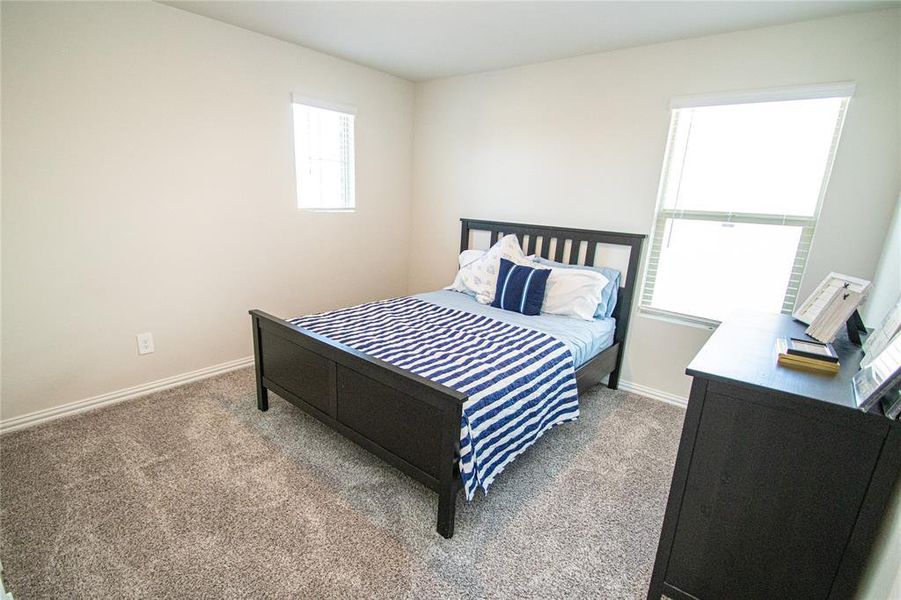 Carpeted bedroom featuring baseboards Carpeted bedroom featuring baseboards