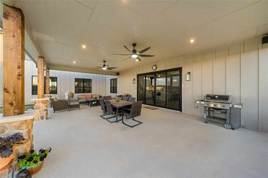 View of patio with outdoor lounge area, a grill, and a ceiling fan