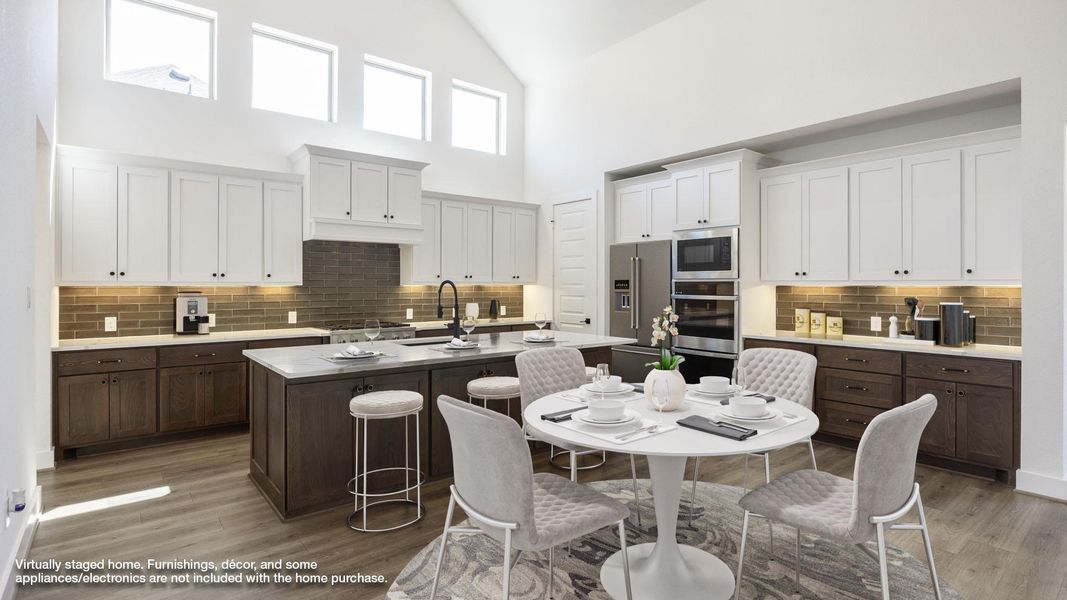 Kitchen with decorative backsplash, dark brown cabinets, high vaulted ceiling, white cabinetry, and a kitchen island with sink Kitchen with decorative backsplash, dark brown cabinets, high vaulted ceiling, white cabinetry, and a kitchen island with sink
