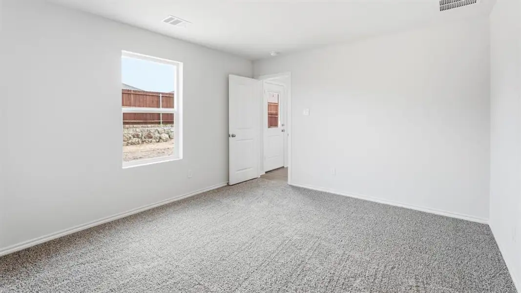 Empty room featuring light carpet and baseboards Empty room featuring light carpet and baseboards