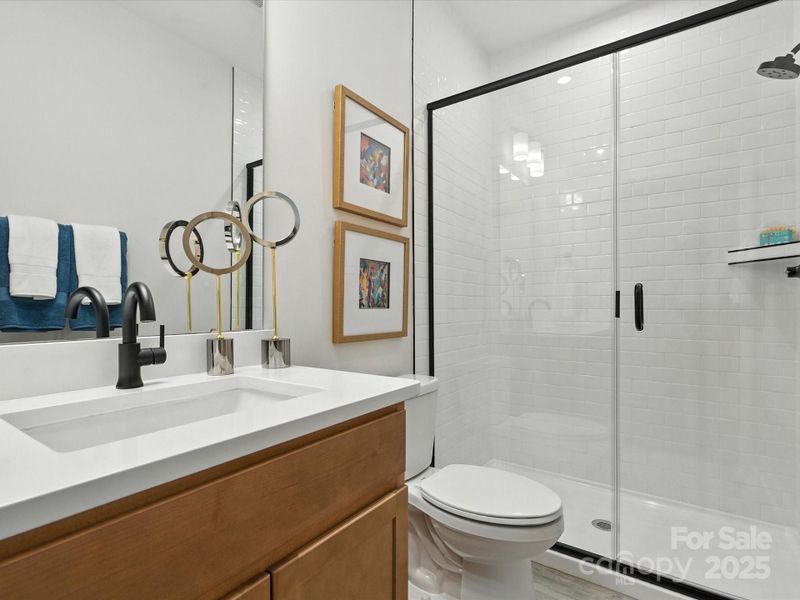 First Floor Guest Bathroom with Tiled Walk-In Shower. *Model Photos | Actual Finishes, Structural Selection, and Orientation May Vary.