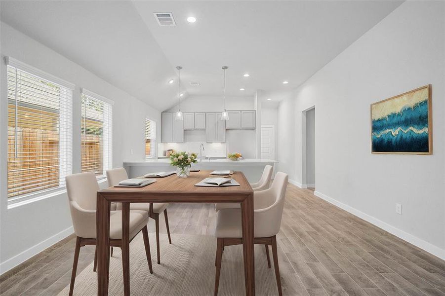 You and your guests will certainly dine in style in this amazing dining room! Featuring large windows with blinds, neutral paint, high ceilings, and wood look tile flooring. Perfect space to entertain family and friends.