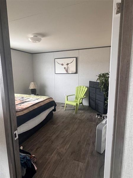 Bedroom with dark wood-style flooring Bedroom with dark wood-style flooring