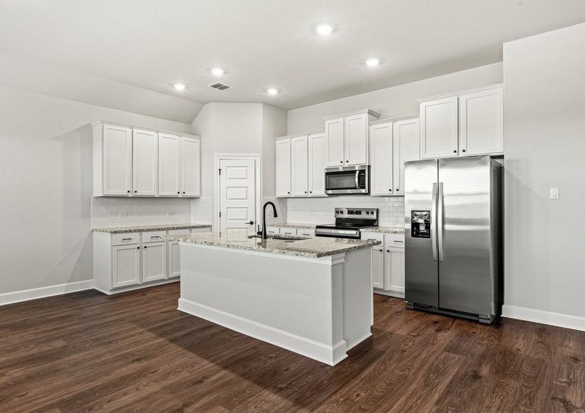 Chef-ready kitchen with an island overlooking the dining room