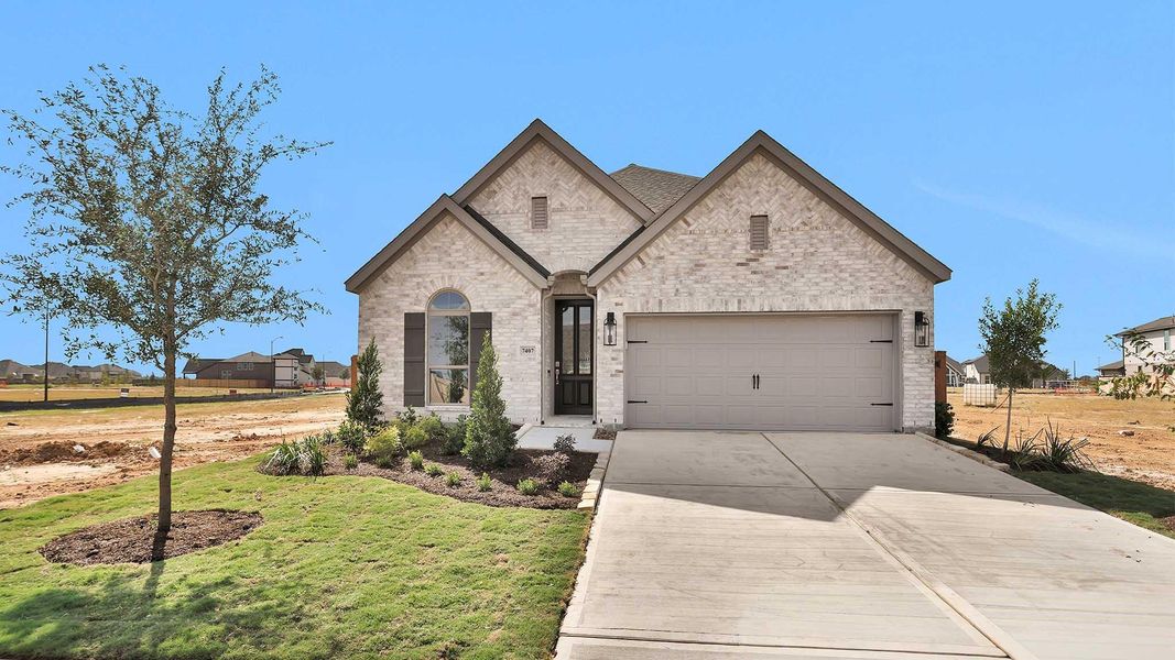 Front exterior of a new home in Elyson 45', Katy, TX, highlighting curb appeal (Image 1).