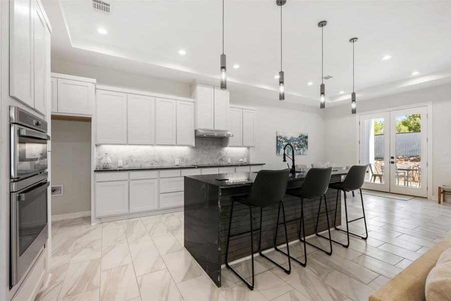 Gorgeous kitchen with sleek black marble counters!