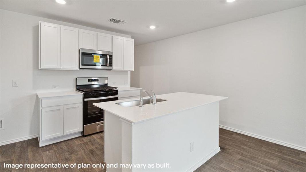 Kitchen featuring appliances with stainless steel finishes, white cabinetry, dark wood-style flooring, an island with sink, and recessed lighting