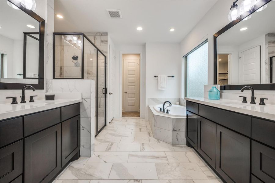 Beautiful Primary Suite with stand alone shower, large bath, beautiful dark cabinets, dual sinks  oil rubber bronze fittings
