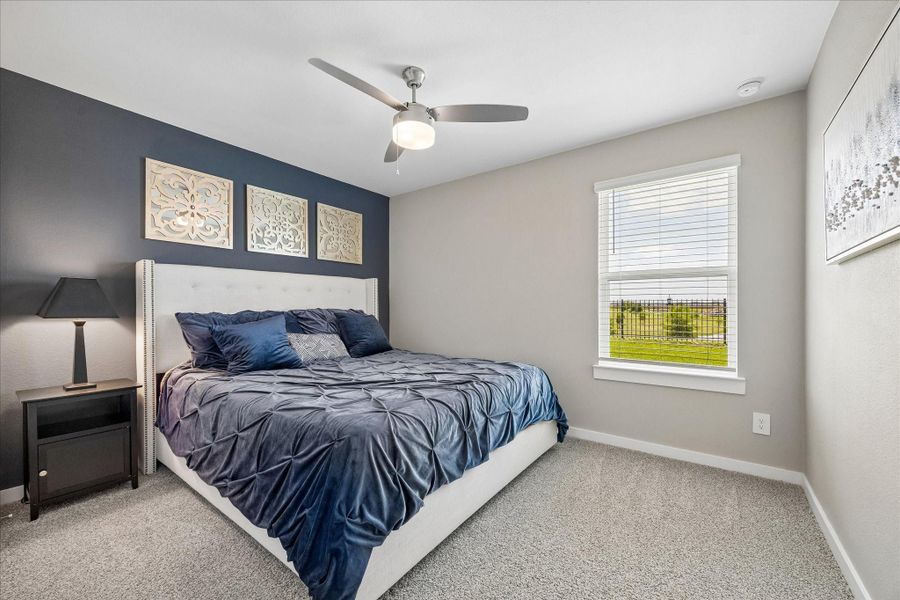 This is the 4th secondary bedroom at the back of the house, with a view of the pond and waterfall.  And an added ceiling fan.