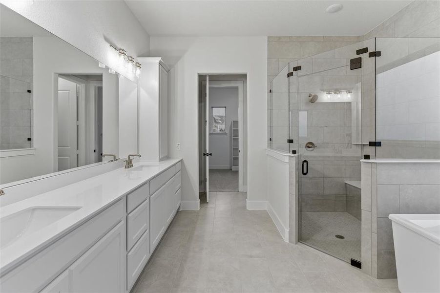 Dual vanity with white cabinetry and integrated sinks, quartz countertop, and brushed nickel fixtures Dual vanity with white cabinetry and integrated sinks, quartz countertop, and brushed nickel fixtures