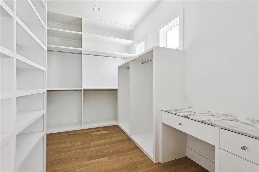 Unfurnished bedroom featuring ceiling fan, light wood-type flooring, ensuite bathroom, and access to exterior