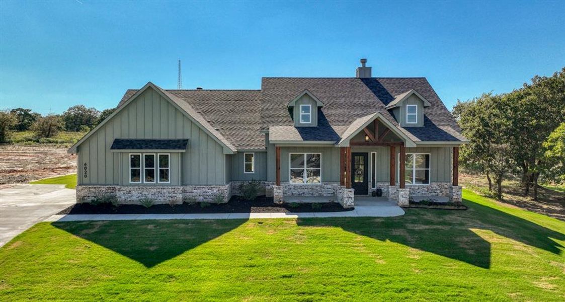 View of front facade with beautifully landscaped front yard