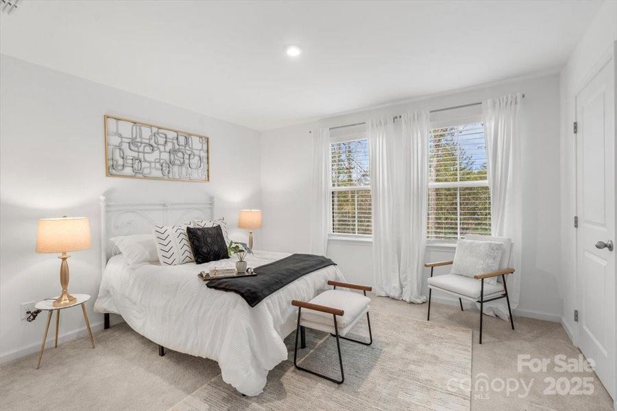 Primary bedroom on the upper level with two custom closets. What do you see out the windows? Not your neighbors!!